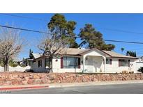Charming single-story home with a well-maintained front yard and a stone retaining wall for added curb appeal at 416 Wyoming St, Boulder City, NV 89005
