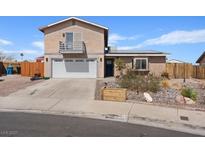 Two-story home featuring a balcony above the garage, complemented by a well-maintained front yard at 429 Sunburst Dr, Henderson, NV 89002
