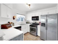 Bright kitchen featuring white cabinetry, stainless steel appliances, and neutral countertops at 4555 E Sahara Ave # 120, Las Vegas, NV 89104