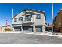 Modern townhome exterior features a balcony and three-car garages at 4790 Equinox Sky Ave # 2, North Las Vegas, NV 89084