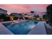 Beautiful backyard pool and spa surrounded by lush landscaping, perfect for relaxing and entertaining at sunset at 640 Hayborn Meadows St, Las Vegas, NV 89138
