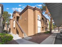 Stylish two-story condo with a staircase leading to the entrance under a partly cloudy blue sky at 9000 Las Vegas Blvd # 2192, Las Vegas, NV 89123