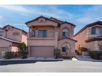 Two-story home with a balcony, arched windows, and a two-car garage, situated between other similar houses at 8307 Amtrak Express, Las Vegas, NV 89131
