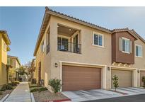 Charming townhome with a private balcony, a brown garage door, and a well-maintained front yard at 25 Barbara Ln # 38, Las Vegas, NV 89183