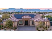 Beautiful single-story home featuring desert landscaping, solar panels, a brick driveway, and views of the Las Vegas skyline at 274 Chartan Ave, Las Vegas, NV 89183