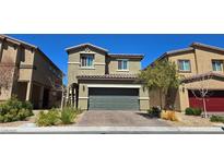 Two-story home features a modern facade, two-car garage, desert landscaping and a beautiful paver driveway at 3820 Ramura Ave, North Las Vegas, NV 89084