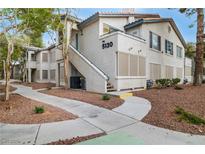 Inviting condo exterior with well-maintained landscaping and visible unit number 5130 at 5130 Mandalay Springs Dr # 102, Las Vegas, NV 89120