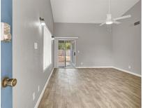 Bright living room with wood floors, sliding door to backyard, and a ceiling fan at 537 Inness Ave, Henderson, NV 89011