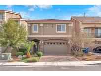 Charming two-story home with red-tiled roof, manicured front yard, and a two-car garage at 5671 Camilla Cellars Ct, Las Vegas, NV 89141
