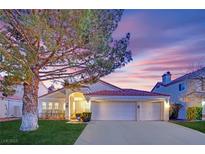 Charming single-story home features a red tile roof, attached two-car garage and a well-manicured front yard at 7405 Blue Sage Ct, Las Vegas, NV 89129