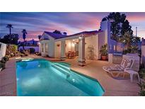 Stunning backyard pool with outdoor kitchen and covered patio, perfect for entertaining at 7405 Blue Sage Ct, Las Vegas, NV 89129