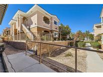 Charming condo complex showcasing stairs leading to upper-level units and well-maintained landscaping at 830 Carnegie St # 724, Henderson, NV 89052
