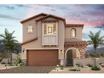 Charming two-story home with a terracotta roof, stone accents, arched doorway, and desert landscaping at 10559 Valletta Ave, Las Vegas, NV 89166