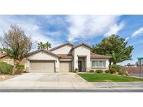 Inviting single-story home featuring a three-car garage and well-manicured front lawn and landscape at 1088 Casady Hollow Ave, Henderson, NV 89012