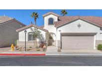 Charming single-Gathering home featuring a two-car garage, desert landscaping, and a red tile roof at 10955 Sospel Pl, Las Vegas, NV 89141