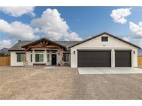 Charming single-story home with a two-car garage and a welcoming front porch at 1660 W Princeton Cir, Pahrump, NV 89060