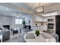Bright, open-concept living room featuring a fireplace and a seamless flow into the modern kitchen at 1701 E Katie Ave # 51, Las Vegas, NV 89119