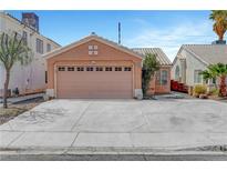 Single Gathering home featuring a two-car garage with a wide concrete driveway and desert landscaping at 1951 Raspberry Hill Rd, Las Vegas, NV 89142
