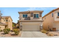 Charming two-story home with neutral stucco, a two-car garage, and manicured landscaping at 232 Dog Leg Dr, Las Vegas, NV 89148