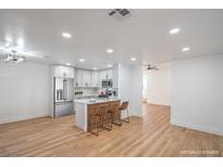 Open-concept kitchen with a modern island, stainless steel appliances, and sleek gray cabinets at 3104 Waterview Dr, Las Vegas, NV 89117