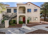 Attractive condo building featuring a red door, stucco facade, and an inviting entrance with steps at 4866 Nara Vista Way # 202, Las Vegas, NV 89103