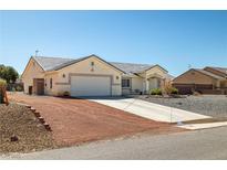Charming single story home featuring a two car garage and desert landscaping at 6751 Stubblefield Dr, Pahrump, NV 89061