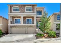Charming two-story home with stone accents, balcony, three-car garage, and landscaped front yard at 6773 Goose Watch Ct, Las Vegas, NV 89139