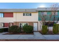Inviting townhome with unique exterior color accents and well-maintained front landscaping at 135 Greenbriar Townhouse Way, Las Vegas, NV 89121