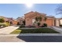 Charming one-story home featuring a lush green lawn and a well-manicured yard at 2143 Vista Famosa Ct, Las Vegas, NV 89123