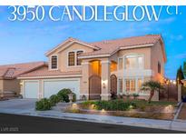 Two-story home with a red tile roof, well-manicured lawn, and a private gated courtyard entrance at 3950 Candleglow Ct, Las Vegas, NV 89147