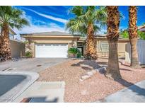 Charming single story home showcasing a manicured yard with palm trees and a two-car garage at 4574 Sheri Lyn Ct, Las Vegas, NV 89121