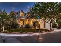 Charming two-story home with a welcoming front porch and well-manicured lawn at 5513 Flowering Meadows Ave, Las Vegas, NV 89131