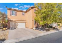 Charming two-story home featuring a stucco exterior, attached garage, and desert landscaping at 11673 Pride Hill St, Las Vegas, NV 89183