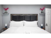 Comfortable bedroom features a padded headboard and stylish decor at 120 Chartan Ave, Las Vegas, NV 89183