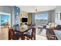 Bright living room with large windows offering city views, wood floors and dining table at 150 Las Vegas Blvd # 918, Las Vegas, NV 89101