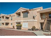 Charming multi-Gathering building featuring a neutral-toned exterior and well-maintained landscaping under a clear blue sky at 1830 N Pecos Rd # 137, Las Vegas, NV 89115