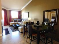 Open-concept living room featuring a large sectional sofa and dining area with seating for eight at 260 E Flamingo Rd # 404, Las Vegas, NV 89169