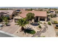 An aerial view of a single-story home with well-maintained desert landscaping and a paver driveway leading to a two-car garage at 2606 Crested Butte St, Henderson, NV 89052