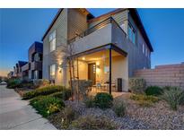 Modern two-story home with a balcony, covered porch and desert landscaping in a quiet neighborhood at 2669 Via Monet, Henderson, NV 89044