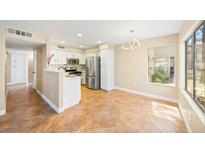 Bright kitchen features stainless steel appliances and tile flooring leading to dining area at 3123 Key Largo Dr # 101, Las Vegas, NV 89120