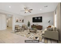 Bright living room showcasing contemporary furnishings, a ceiling fan, and neutral decor at 350 Night Dove St, Henderson, NV 89011