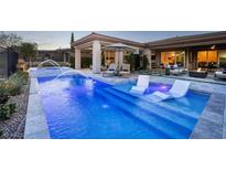 Beautiful pool with water features and lounge chairs offers a relaxing outdoor space at 47 Reflection Bay Dr, Henderson, NV 89011