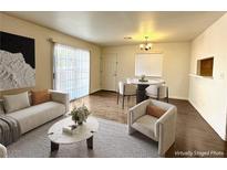 Bright living room showcasing neutral walls, modern furniture, and a dining area with a round table at 5384 Hanging Tree Ln, Las Vegas, NV 89118