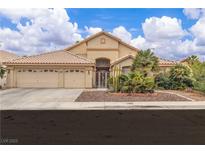 Charming single-story home with a three-car garage, desert landscaping, and a welcoming front entrance at 5513 Oakview Falls Ct, Las Vegas, NV 89148