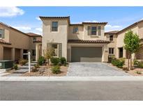 Charming two-story home with a two-car garage, desert landscaping, and a brick paver driveway at 6545 Vanhoven Crest St, Las Vegas, NV 89166