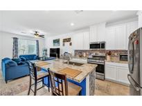 Bright open-concept kitchen with stainless steel appliances and granite countertops, connecting to the living room at 7364 N Decatur Blvd # 4, Las Vegas, NV 89131