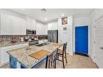 Bright kitchen features granite countertops, stainless steel appliances, and white cabinetry at 7364 N Decatur Blvd # 4, Las Vegas, NV 89131