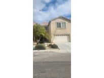 Two-story home with tan siding, attached garage and minimal landscaping at 9162 Weeping Hollow Ave, Las Vegas, NV 89178