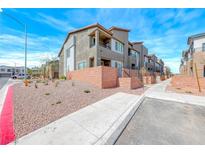 Beautiful townhome featuring modern architecture and drought-resistant landscaping at 1540 Eva Crossing Pl, Henderson, NV 89002