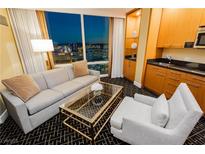 Comfortable living area with city views, wet bar, stylish furniture, and geometric patterned carpet at 2000 Fashion Show Dr # 5300, Las Vegas, NV 89109